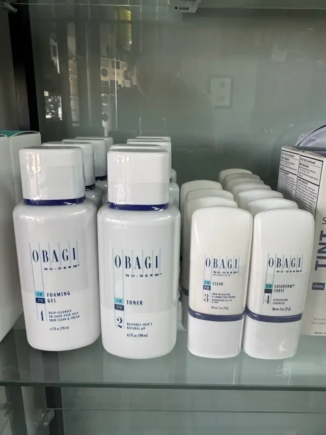 Obagi Nu-Derm bottles numbered one to four on a glass shelf